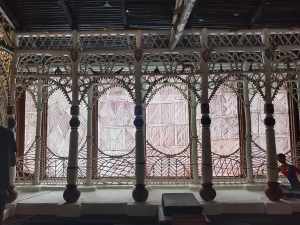 Verandah enclosed by carved timber fretwork screens and turned columns