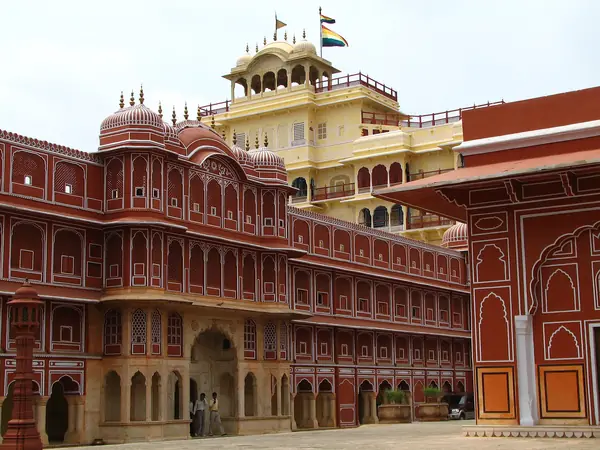 Pink sandstone palace facade with tiered balconies and arches
